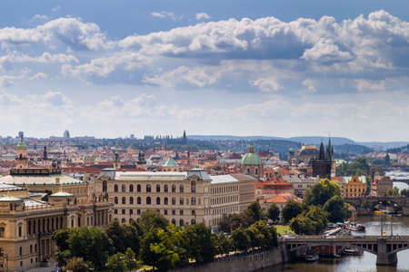 Scenic view of bridges on the Vltava river and of the historical center of Prague: buildings and landmarks of old town with red rooftops and multi-coloured walls.の写真素材
