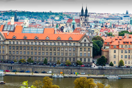 Scenic view of bridges on the Vltava river and of the historical center of Prague: buildings and landmarks of old town with red rooftops and multi-coloured walls.の写真素材