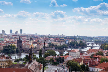 Scenic view of bridges on the Vltava river and of the historical center of Prague: buildings and landmarks of old town with red rooftops and multi-coloured walls.のeditorial素材