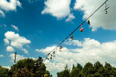 Scenic view of shoes hanging over the Vltava river and the historical center of Prague: houses, buildings and the characteristic and picturesque red rooftops and multi-coloured walls.のeditorial素材