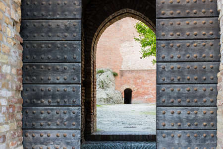 The entry in the brick walls of the medieval Fortress of Venetians in Brisighellaの写真素材