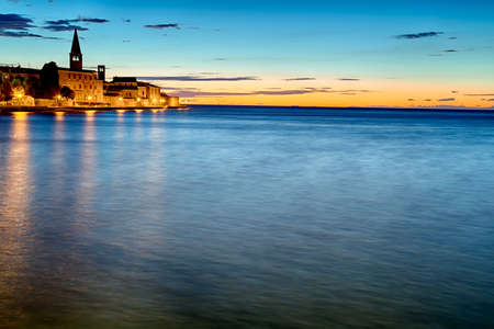 Night view of the bay of Porec in Istria, Croatia in Europe: Euphrasian Basilica on the backgroundの写真素材