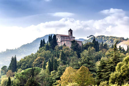 Sanctuary of the Blessed Virgin of Monticino surrounded by cypress trees, in Brisighella in Italy.  View from the medieval Fortress of Venetiansのeditorial素材