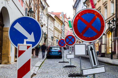 Misguiding road signs among Buildings  and houses in the historical center of Prague