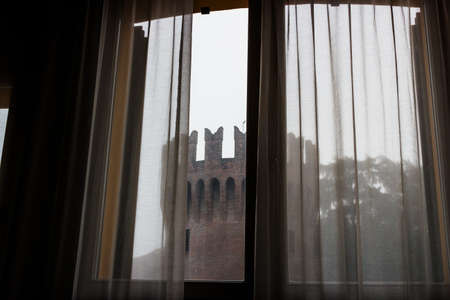 window overlooking medieval tower in the fog in Lugo near Ravenna in the region of Emilia Romagna in Italy.のeditorial素材