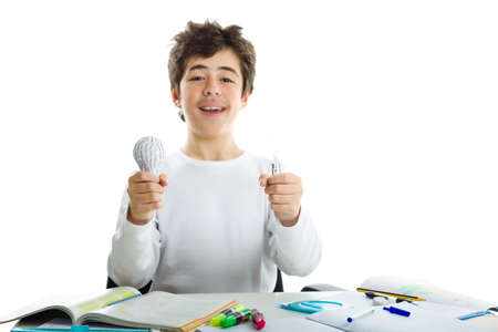 Smiling Caucasian boy wearing a white long sleeve t-shirt is holding a real glass lightbulb and a 3D...