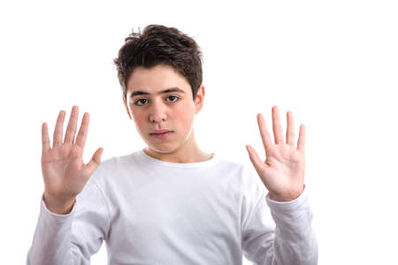 Caucasian smooth-skinned teen in a white long sleeve t-shirt uses downward hand gestures showing palms with both hands exposing wrists meaning heâs telling the truth and he should be trustedの写真素材