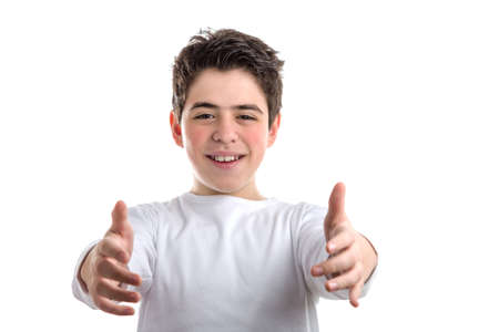 Handsome Caucasian smooth-skinned boy in a white long sleeved t-shirt smiles and opens arms to offer...