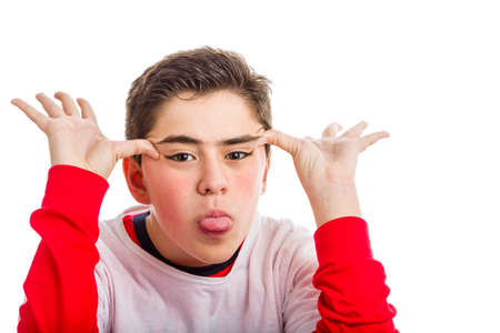 A Caucasian boy wearing red long sleeved shirt makes faces with both hands showing his tongueの写真素材
