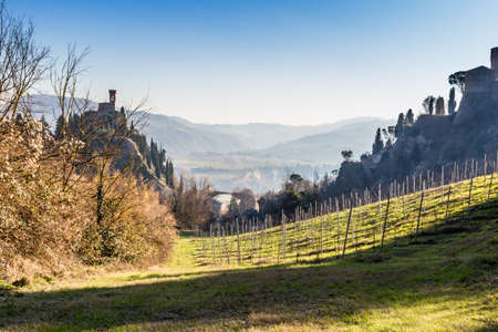The brick walls of a medieval fortress and medieval crenellated clock tower on hills in the countrysideのeditorial素材