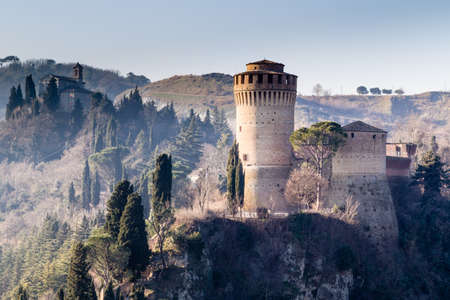 The brick walls of a medieval fortress and a sanctuary with belfry devoted to Blessed Virgin Mary on hills in the countrysideのeditorial素材