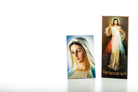 Icons  of Merciful Jesus and Our Lady of Medjugorje, the Blessed Virgin Mary isolated on white background with matte reflection on white table.の写真素材