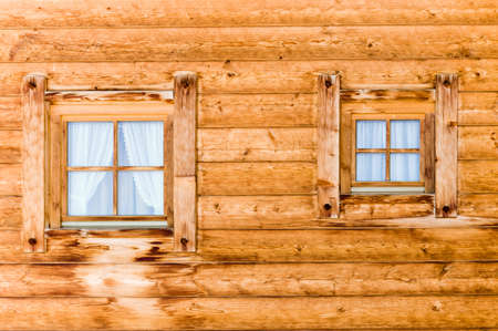 mountain cabin glass windows with curtains in wooden wallの写真素材