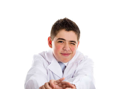 A boy doctor in white coat and blue tie helps to feel medicine more friendly: he is stretching his arms.. His acne skin has not ben retouchedの写真素材