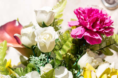 fake laminated paper flowers in a cemeteryの写真素材