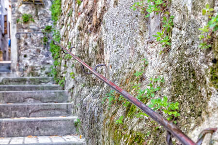 Ancient stone stairs with handrails in a street in the old town of a country village in countryside of Romagnaの写真素材