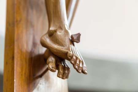 Detail of nailed feet in a wood carved statue  of the Crucifixion of Jesus Christの写真素材