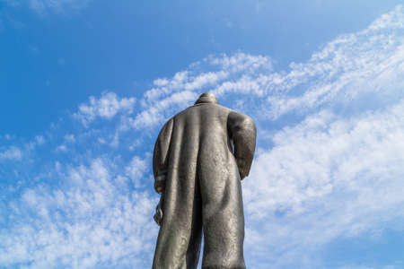 Statue with fat bottom in large trousers on sky backgroundの写真素材