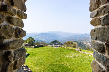 historic feeling comes out of Ruins of medieval fortress, Rocca di Monte Battaglia, on hills in the countryside in Italyの写真素材