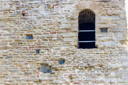 historic feeling comes out of Ruins of medieval fortress, Rocca di Monte Battaglia, on hills in the countryside in Italyの写真素材