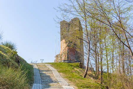 historic feeling comes out of Ruins of medieval fortress, Rocca di Monte Battaglia, on hills in the countryside in Italyの写真素材