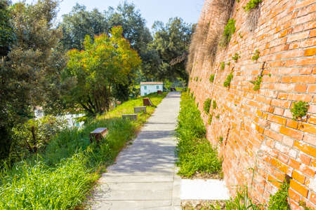 paved path along the wall of a 14th century fortressの写真素材
