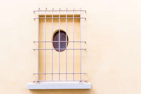 Lilac iron grating window with round hole on vintage wallの写真素材