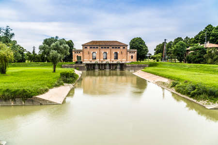 the charm of industrial archeology - a dewatering pump in sluice of the beginning of XX century still working in Italy, in Valle Santa, near Argentaの写真素材