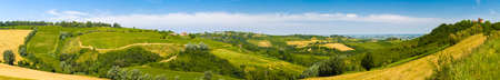 Ancient ruins of stronghold overlooking the vibrant colors of Agricultural cultivated fields in...