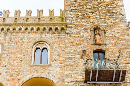 architecture in the Middle Ages - the civic tower adjacent to the town hall of bertinoro with its characteristic brick wallsの写真素材