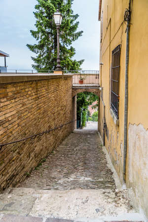 medieval streets and ancient memories - the maze of alleys of a medieval village in Italy, between historical buildings and private homesの写真素材