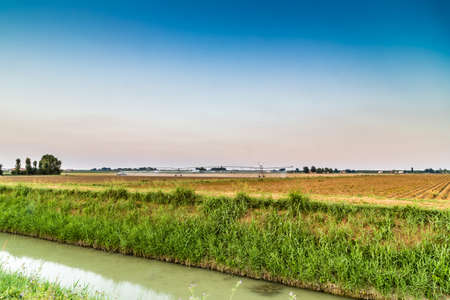 irrigation systems in modern agriculture - the modern machinery for irrigation related to ancient irrigation canals allow more effective management of waterの写真素材