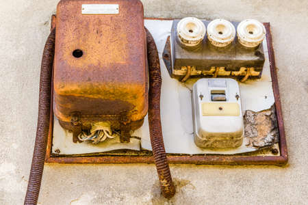 Electrotechnical industrial archeology - old electric light switch and electrical panel with valves and fusesの写真素材
