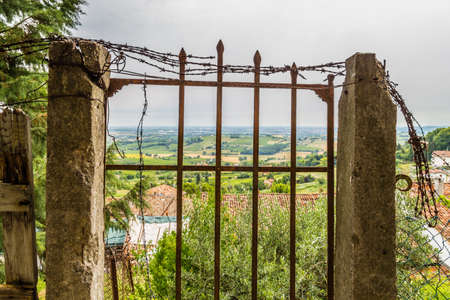 old rusty gate in ruins overlooking the countryside dell'Emilia Romagna in Italyの写真素材
