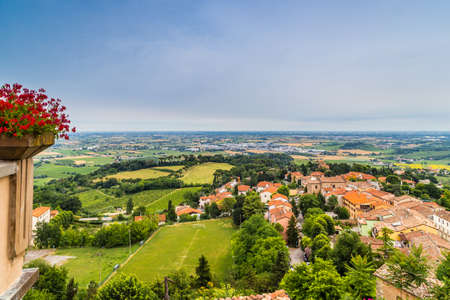 nature and memories - view from the terrace of the medieval village of bertinoro in Italy overlooking the hills of the Romagna countryside sloping down to the seaの写真素材