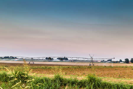 irrigation systems in modern agriculture - the modern machinery for irrigation related to ancient irrigation canals allow more effective management of waterの写真素材