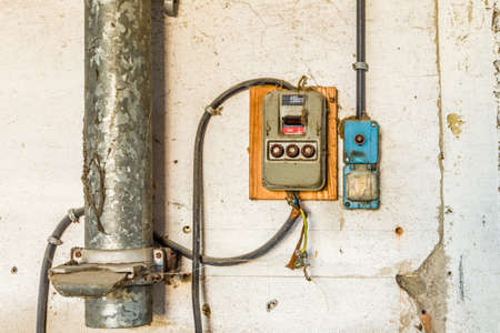 Electrotechnical industrial archeology - old electric light switch old and electrical panel with...