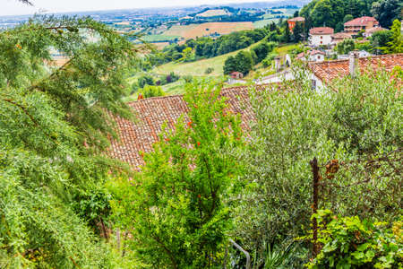 nature and memories - view from the terrace of the medieval village of bertinoro in Italy overlooking the hills of the Romagna countryside sloping down to the seaの写真素材