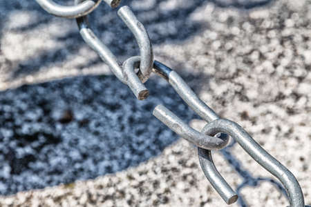 the link in the chain is opening: this weak link defines the real strength of this steel chainの写真素材