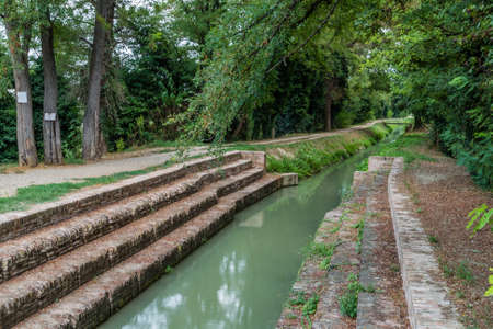 The ancient stone steps of the Washerwomen bridge on the channel of old mills in Lugo in the Emilia Romagna region in Italyの写真素材