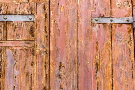 old weathered door with rusty nails and peeling copalの写真素材