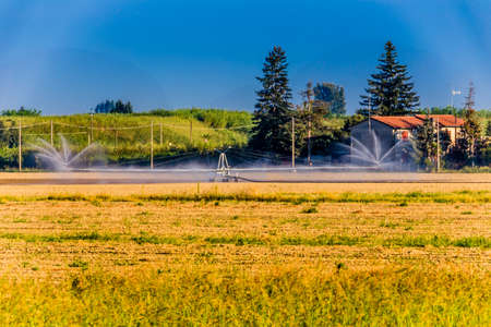 irrigation of farmland in summer in Italian countrysideの写真素材