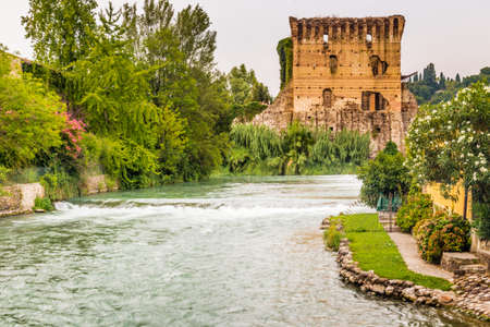 ancient buildings of a typical Italian medieval village: the river runs through the town, still passing under houses and old millsの写真素材