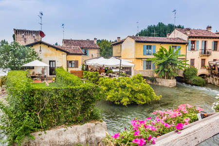 ancient buildings of a typical Italian medieval village: the river runs through the town, still passing under houses and old millsの写真素材
