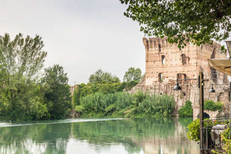 ancient buildings of a typical Italian medieval village: the river runs through the town, still passing under houses and old millsの写真素材
