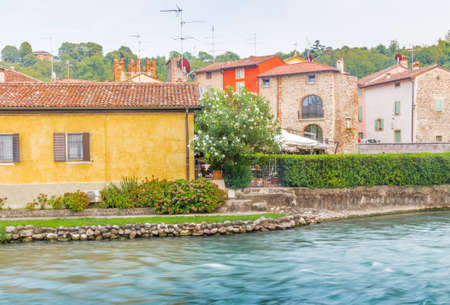 ancient buildings of a typical Italian medieval village: the river runs through the town, still passing under houses and old millsの写真素材