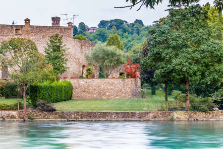 ancient buildings of a typical Italian medieval village: the river runs through the town, still passing under houses and old millsの写真素材