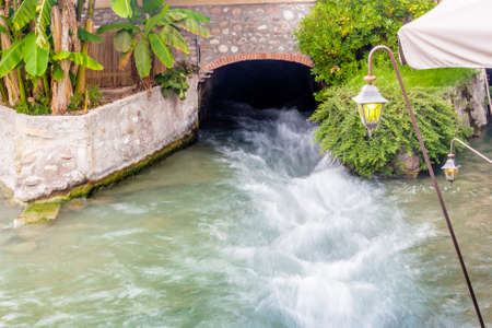 ancient buildings of a typical Italian medieval village: the river runs through the town, still passing under houses and old millsの写真素材