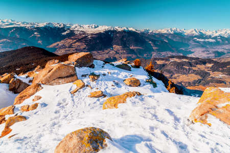 White snowy Dolomites mountains with rocks, snow-capped peaks and green conifers in winter