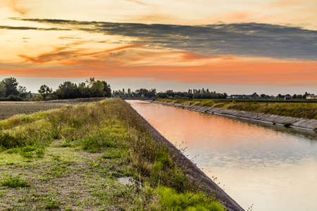 Channel to divert river water for irrigation of cultivated fieldsの写真素材